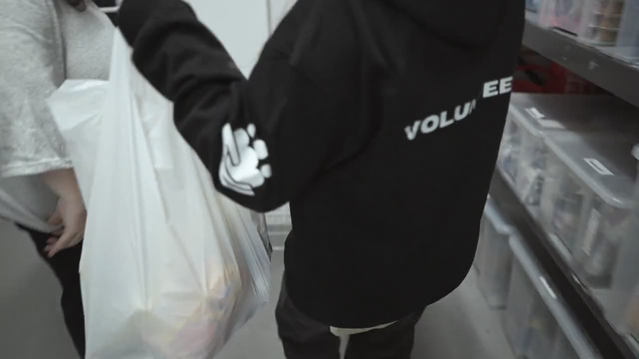 A volunteer carrying food parcels at the AR Projects food bank