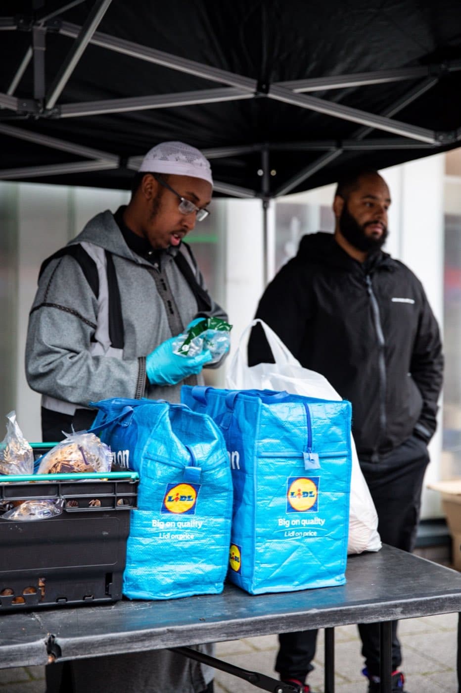 A volunteer serving food at the AR Projects soup kitchen