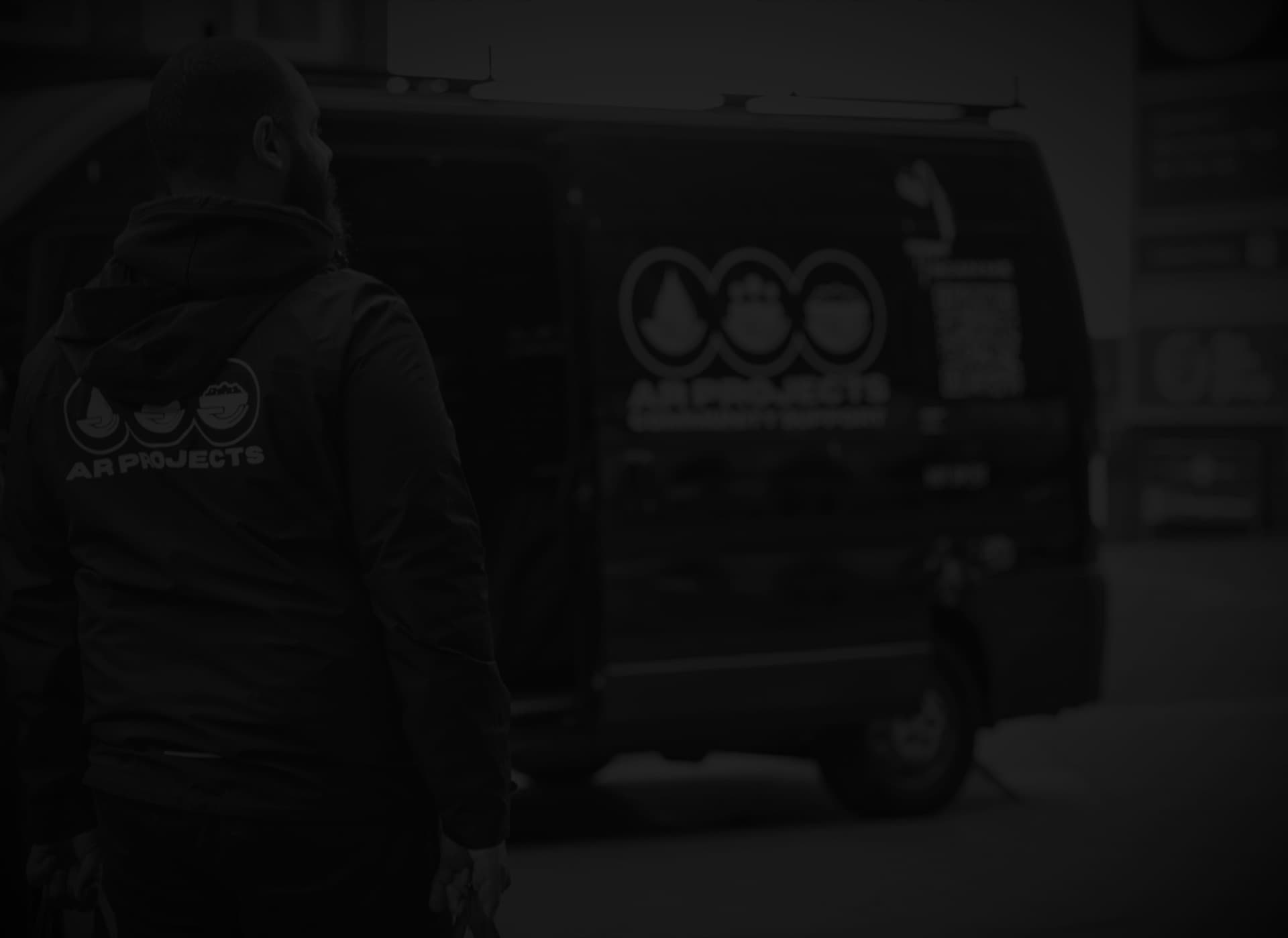 An AR Projects volunteer with the van that carries surplus food